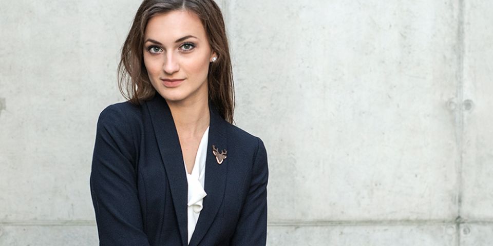 A woman in a jacket with the wooden brooch Deer Brooch