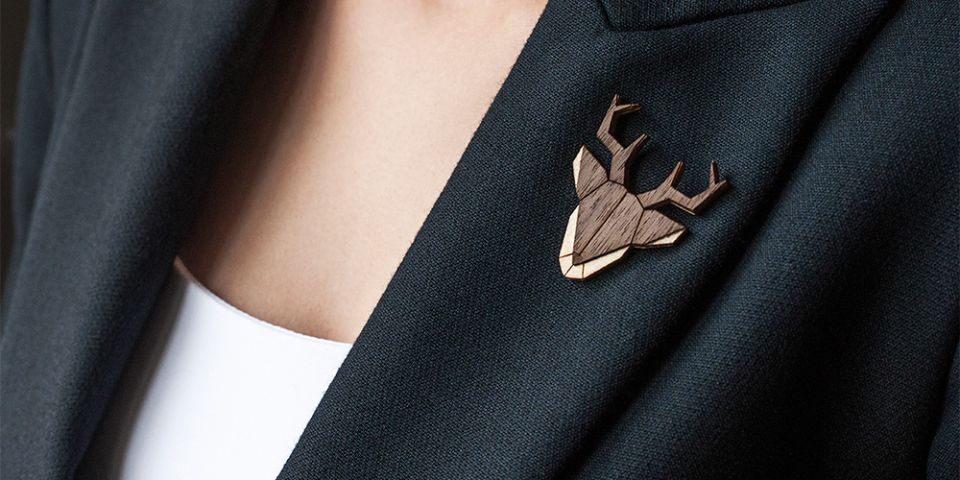 A woman in a jacket with the wooden brooch Deer Brooch