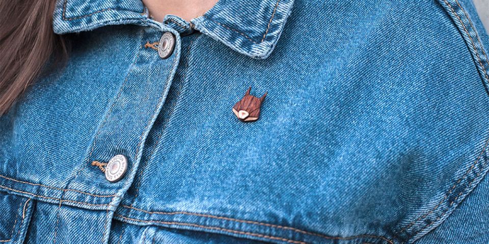 A woman in jeans jacket with the wooden brooch Squirrel Brooch