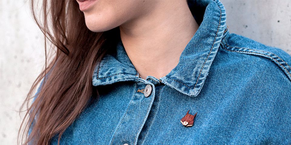 A woman in jeans jacket with the wooden brooch Squirrel Brooch