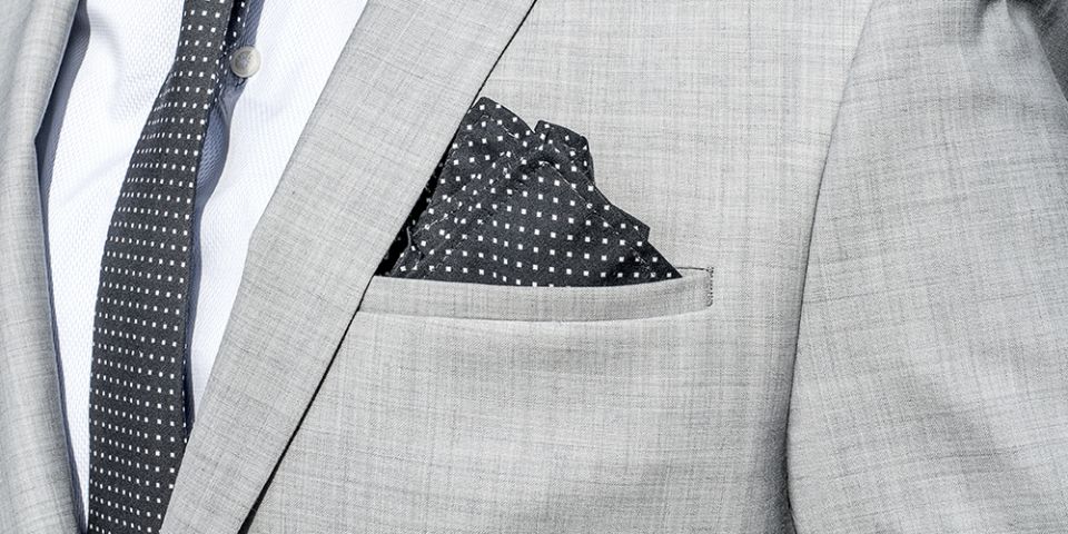 Man in a gray jacket with Coloo pocket square and Coloo Tie