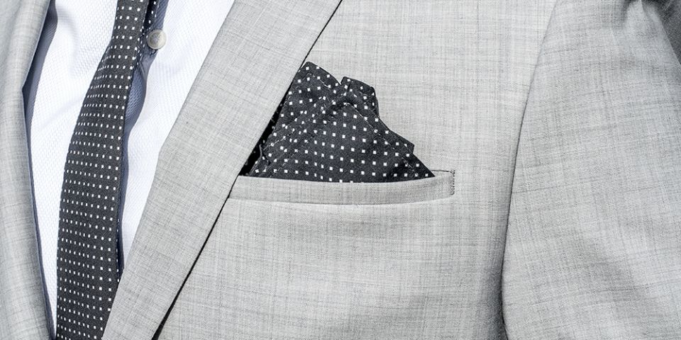 Man in a gray jacket with Coloo pocket square and Coloo Tie Man in a gray jacket with Coloo pocket square and Coloo Tie