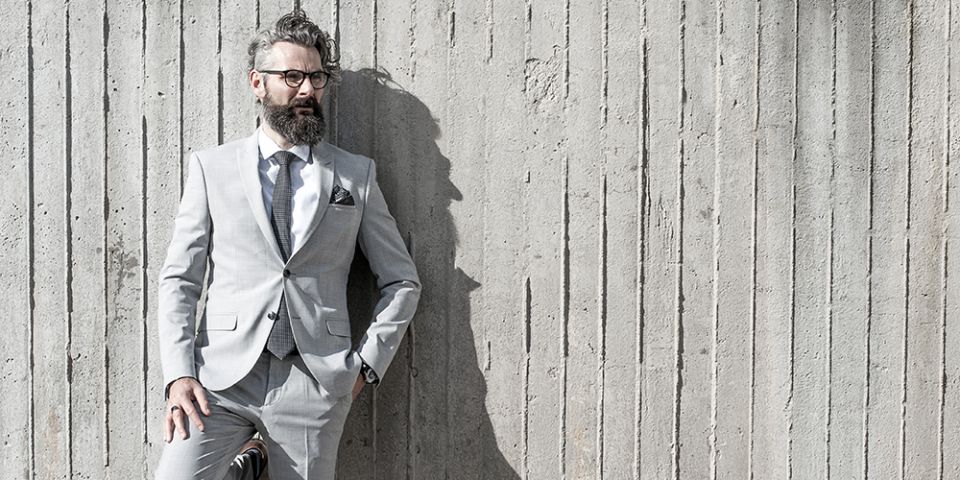 Man in a gray jacket with Coloo pocket square and Coloo Tie