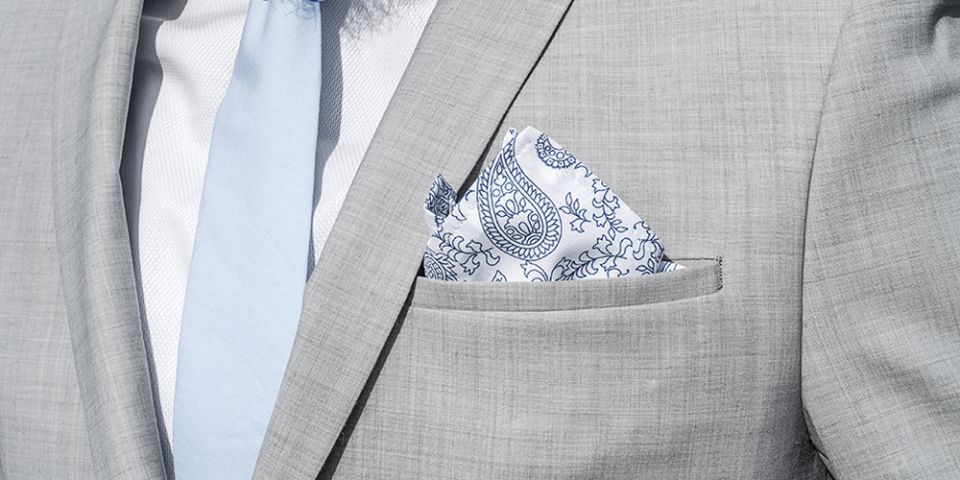 Man in a gray jacket with Shells pocket square and tie Man in a gray jacket with Shells pocket square and tie