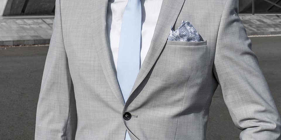 Man in a gray jacket with Shells pocket square and tie Man in a gray jacket with Shells pocket square and tie